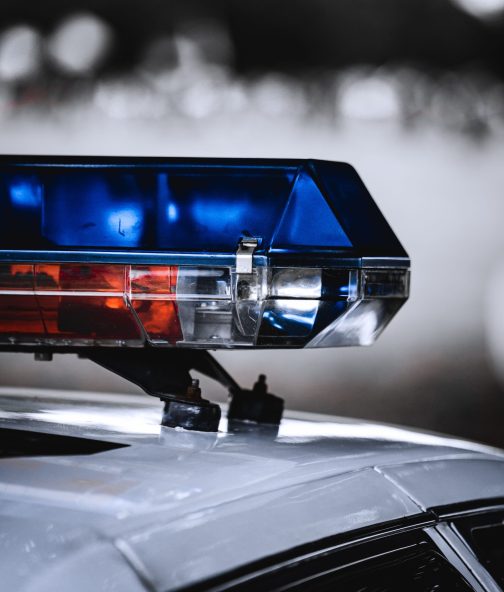 A vertical closeup of a police car emergency light siren
